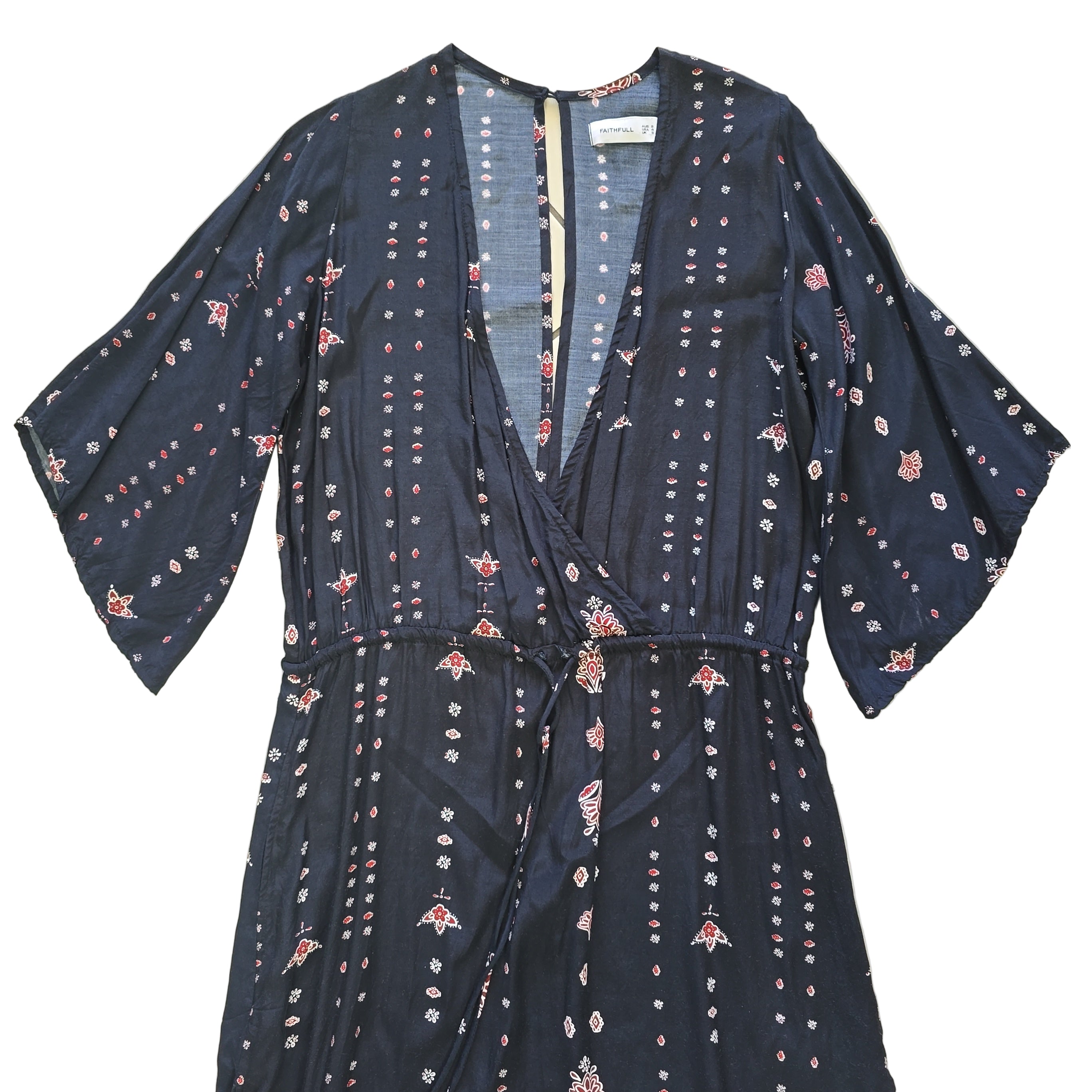 Black dress with white and pink patterns on a light background