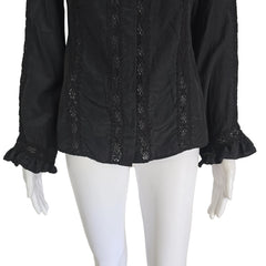 Black lace-trimmed garment on a mannequin against a beige background