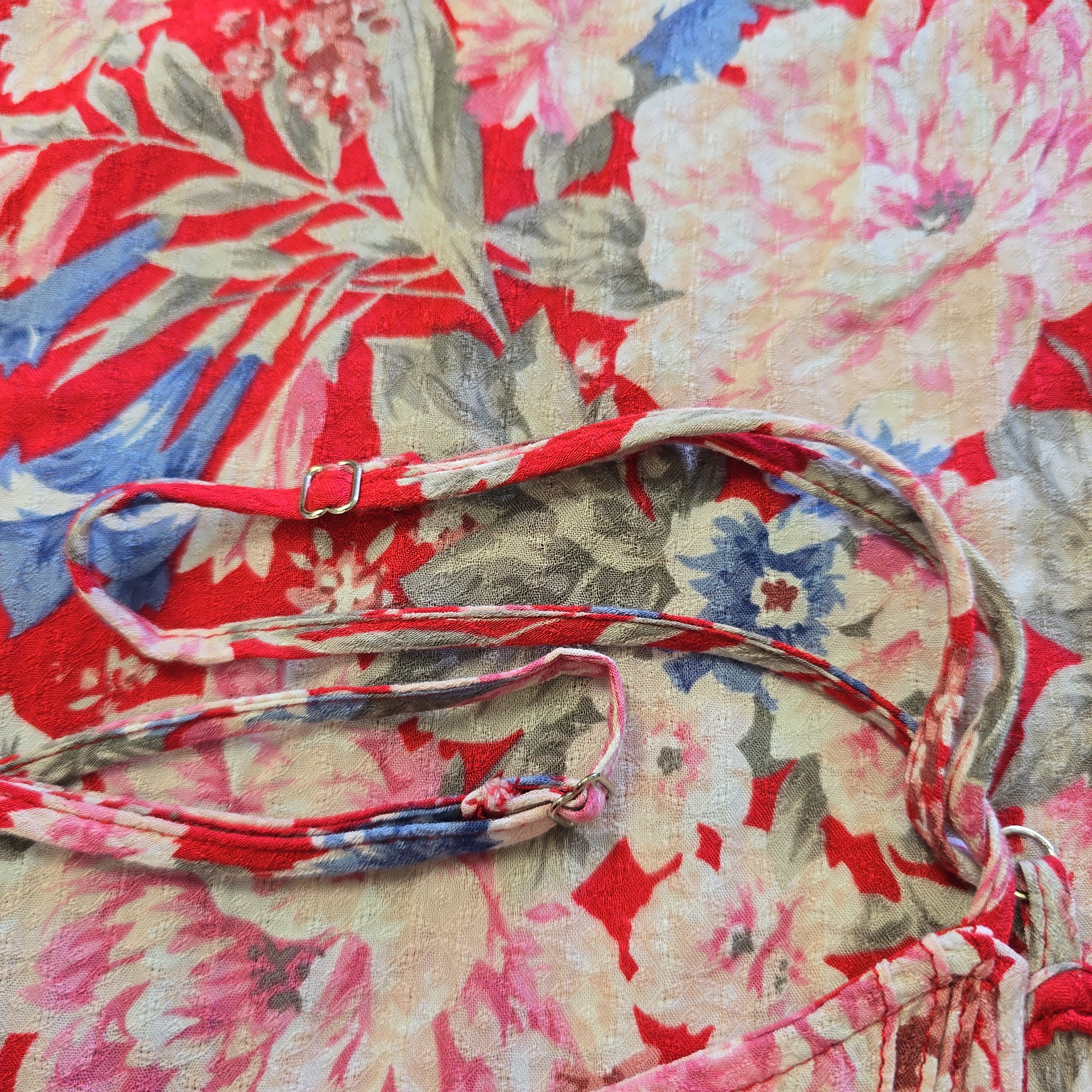 Floral-patterned strap on a floral fabric background