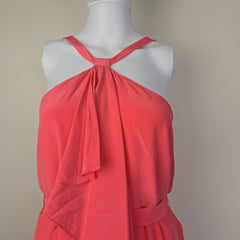 Pink dress on a mannequin against a plain background