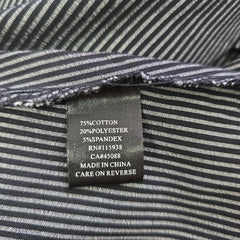 Close-up of a label on a striped fabric garment with text details.