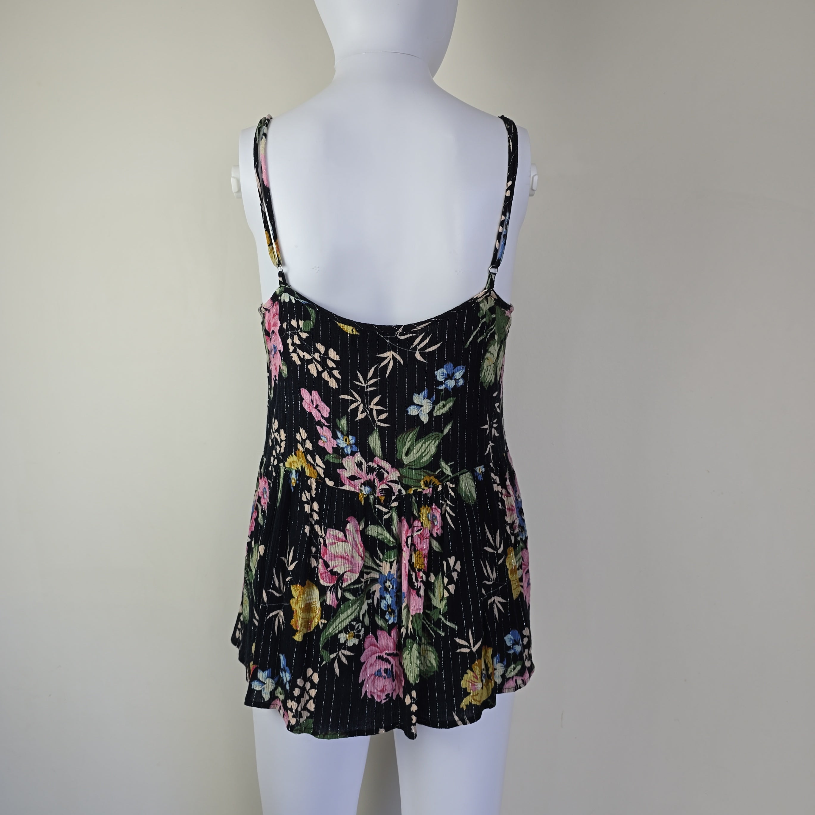 Black floral-patterned top on a light background