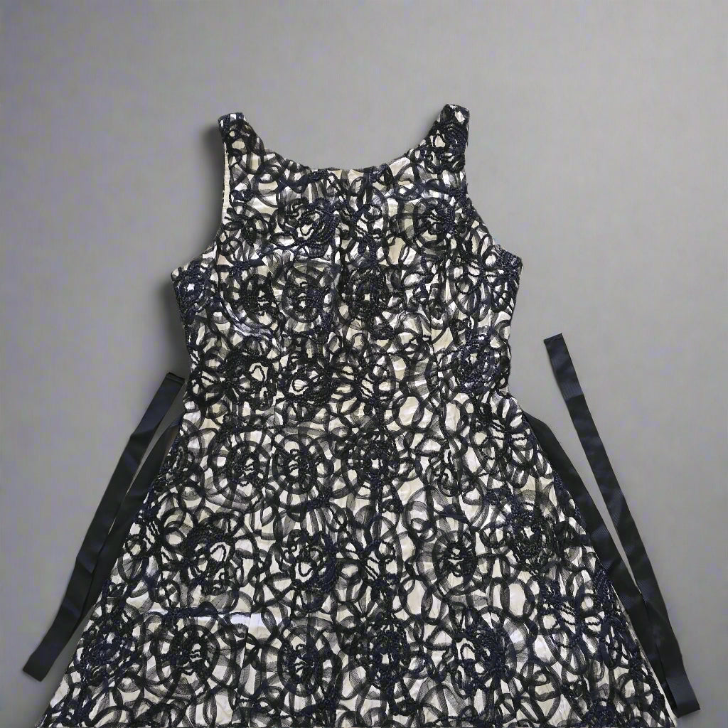 Black lace dress on a tiled floor