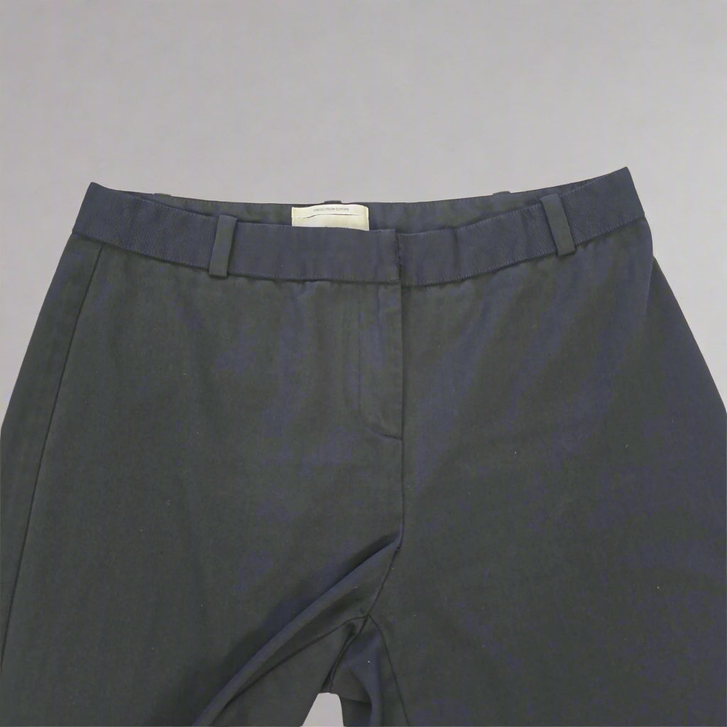 Black Pants on a light beige tiled floor