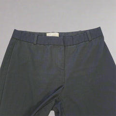 Black Pants on a light beige tiled floor