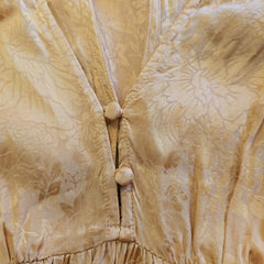 Close-up of a gold textured fabric with a belt
