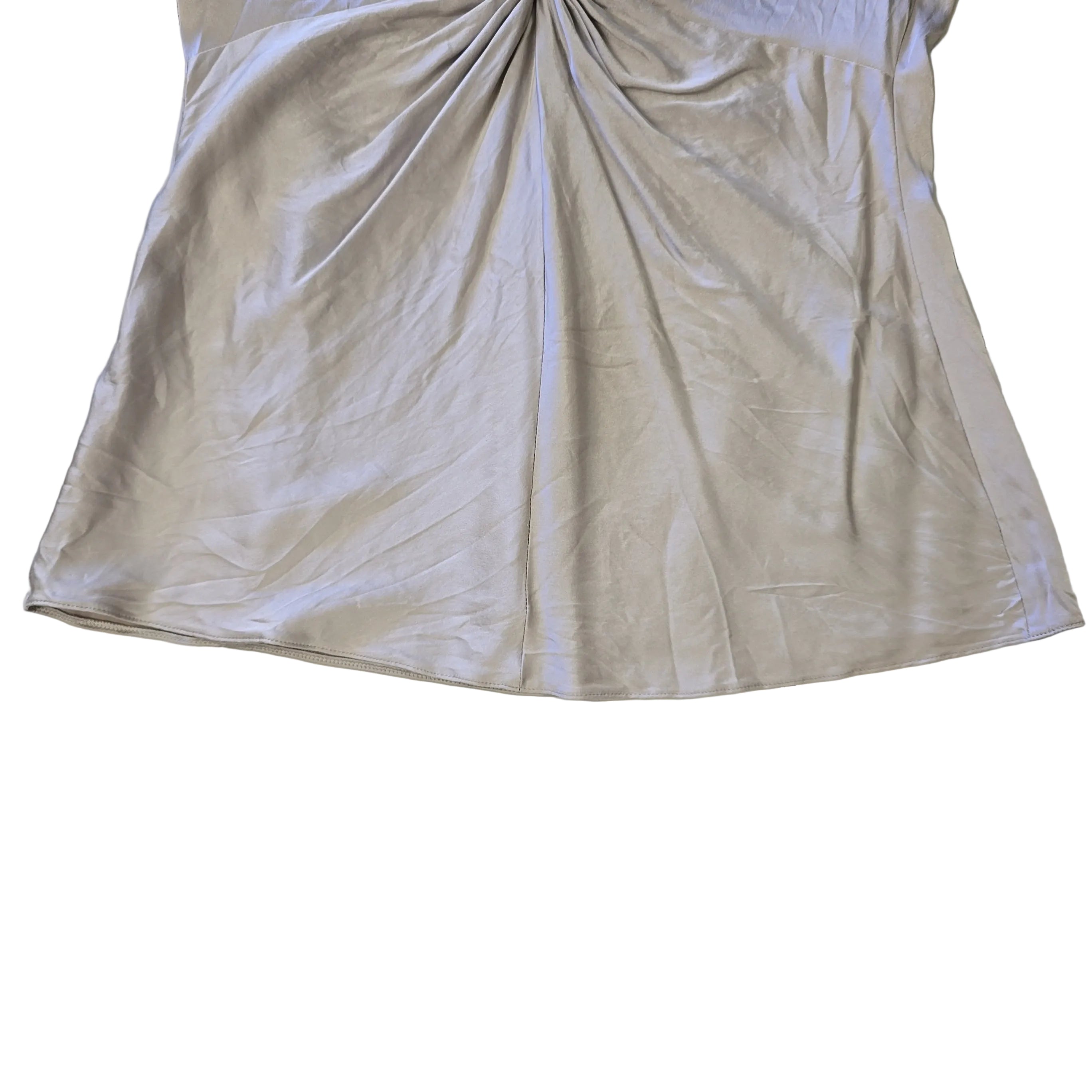 Beige top with a knot detail on alight floor