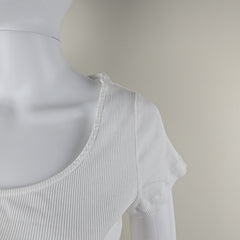 White ribbed tank top on a mannequin against a neutral background