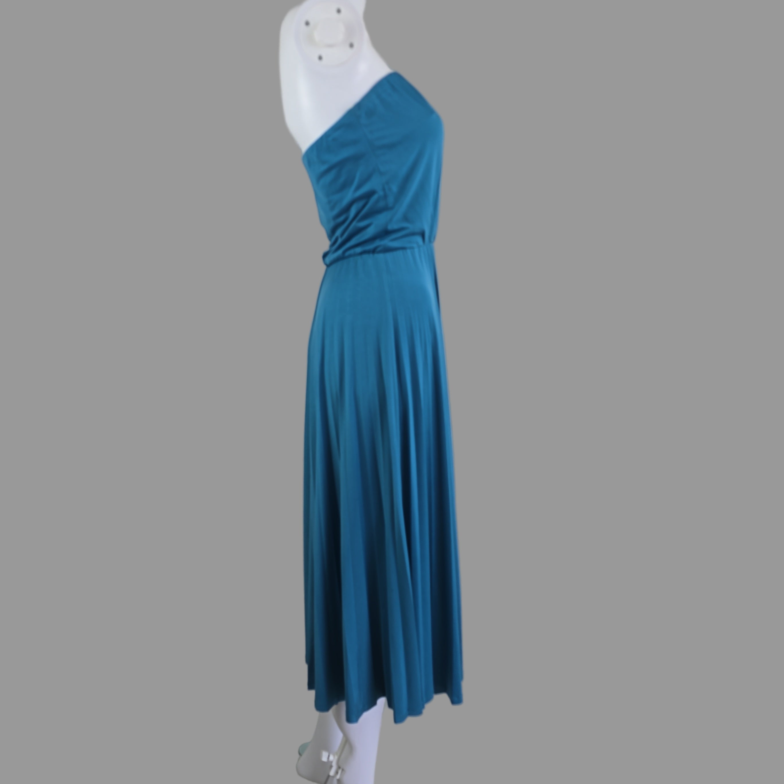 Blue dress on a mannequin arm against a white background