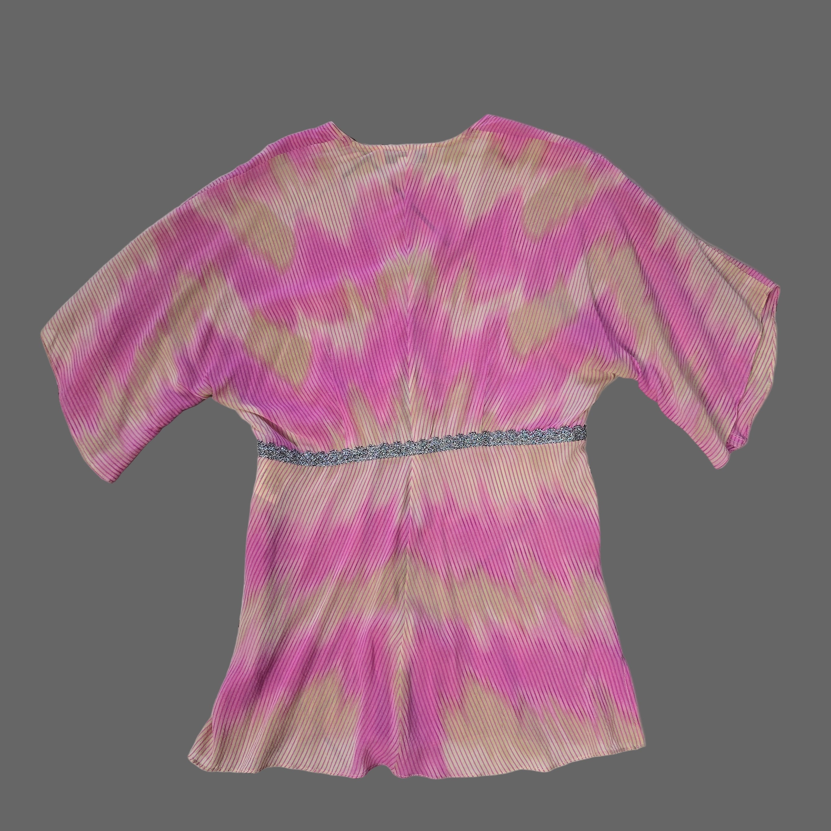 Pink and beige patterned fabric on a tiled floor