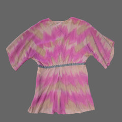 Pink and beige patterned fabric on a tiled floor