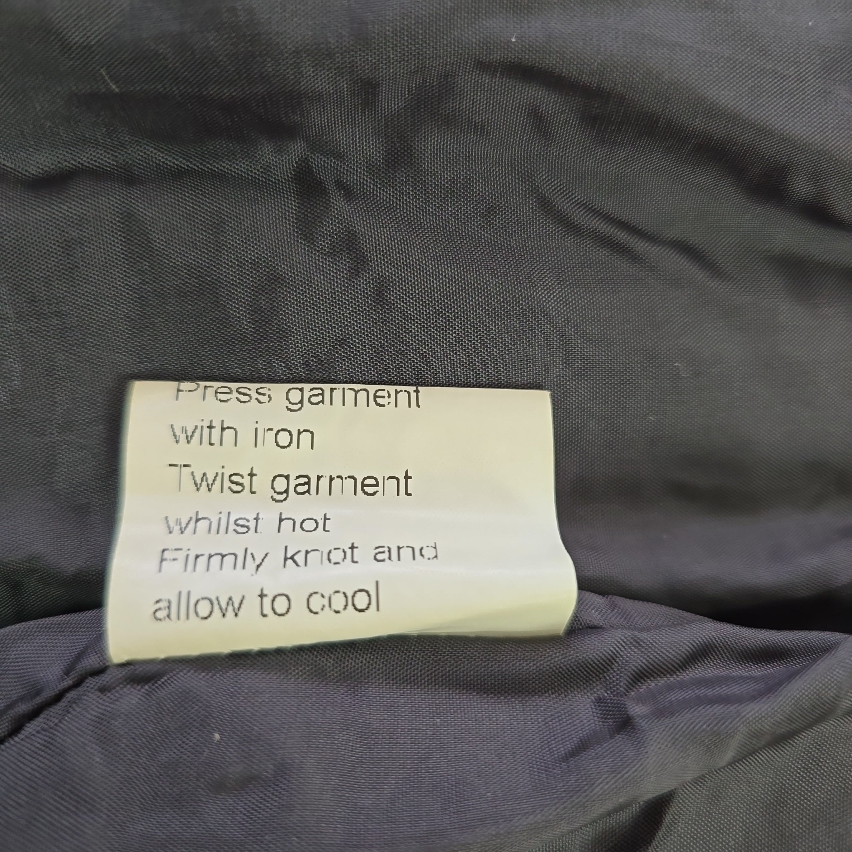 Clothing label on a dark fabric background