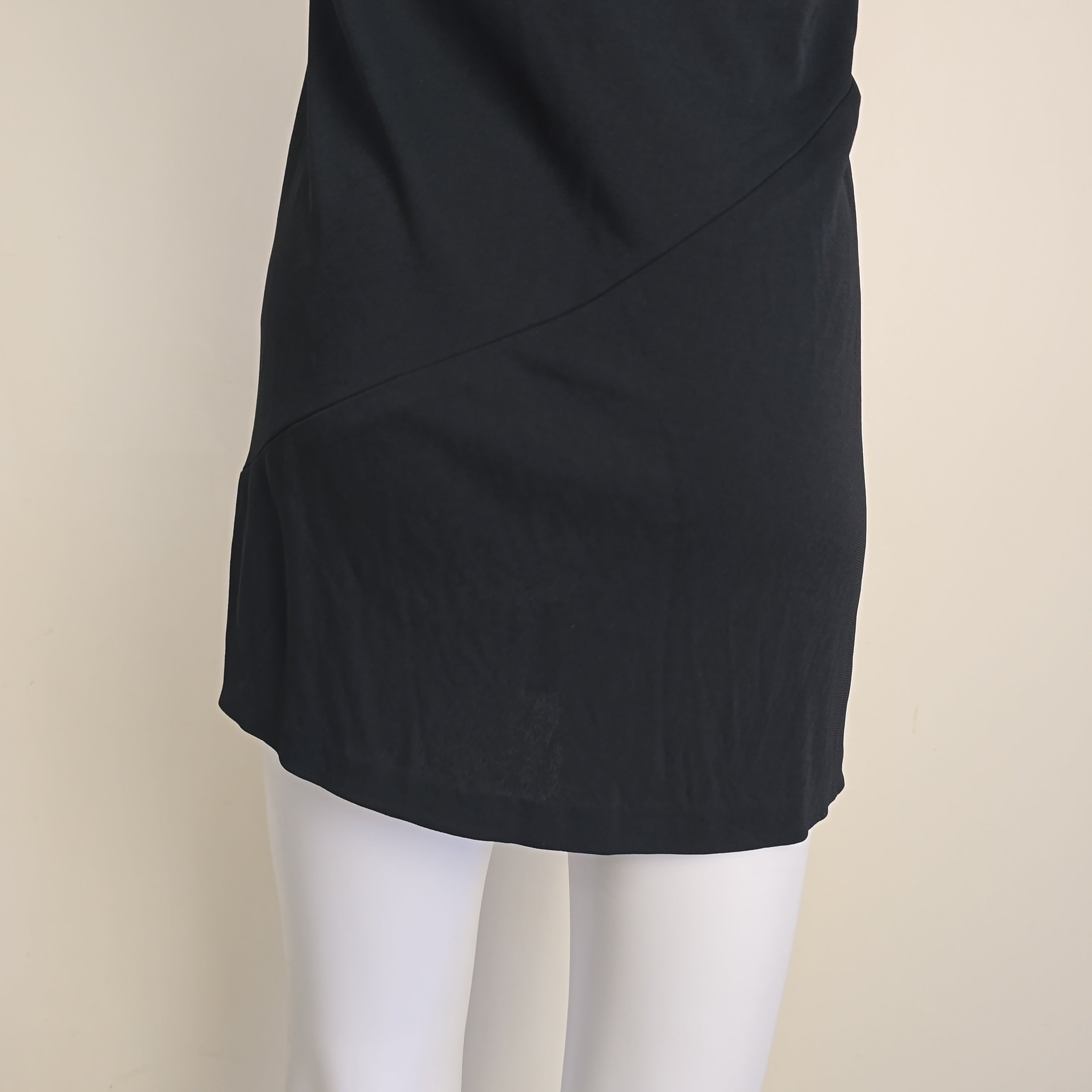 Black skirt on a mannequin against a beige background