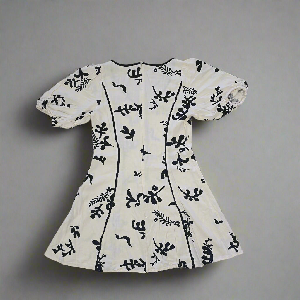 White fabric with black floral patterns on a tiled floor