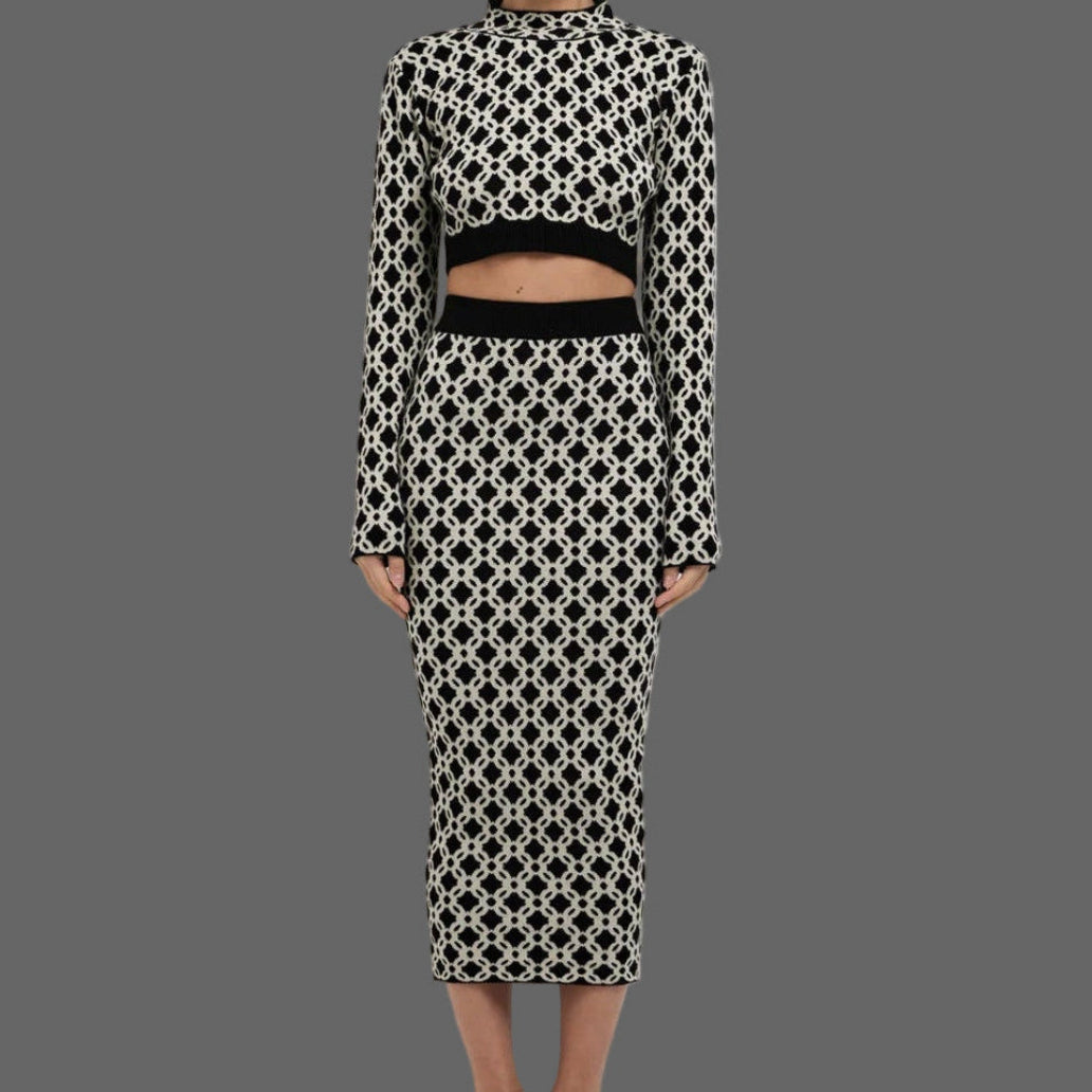 Woman wearing a black and white patterned outfit on a white background