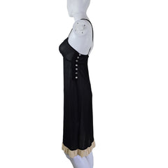 Black dress on a mannequin against a plain background