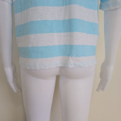 Mannequin wearing a blue and white striped garment on a plain background