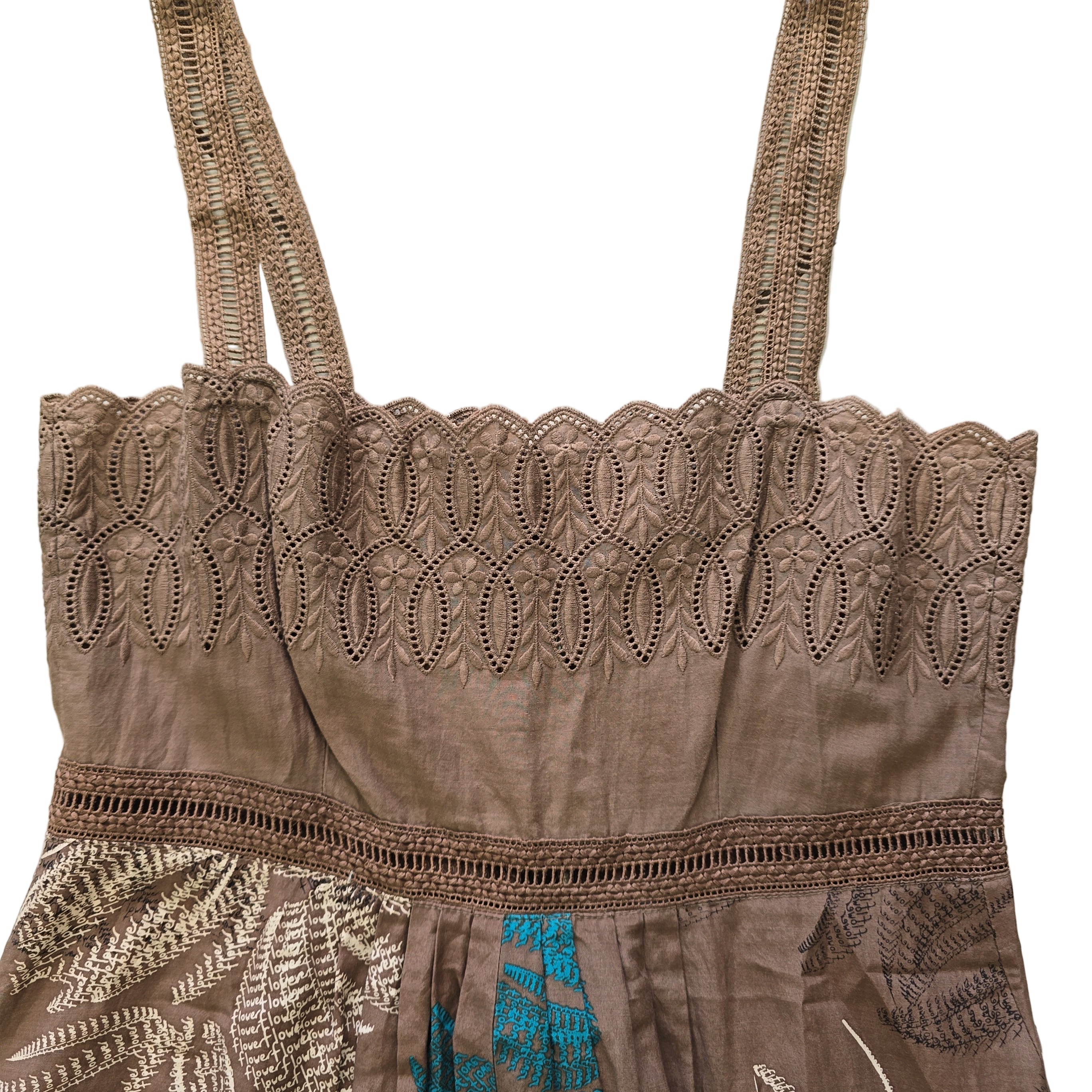 Brown lace top with intricate patterns on a tiled floor background