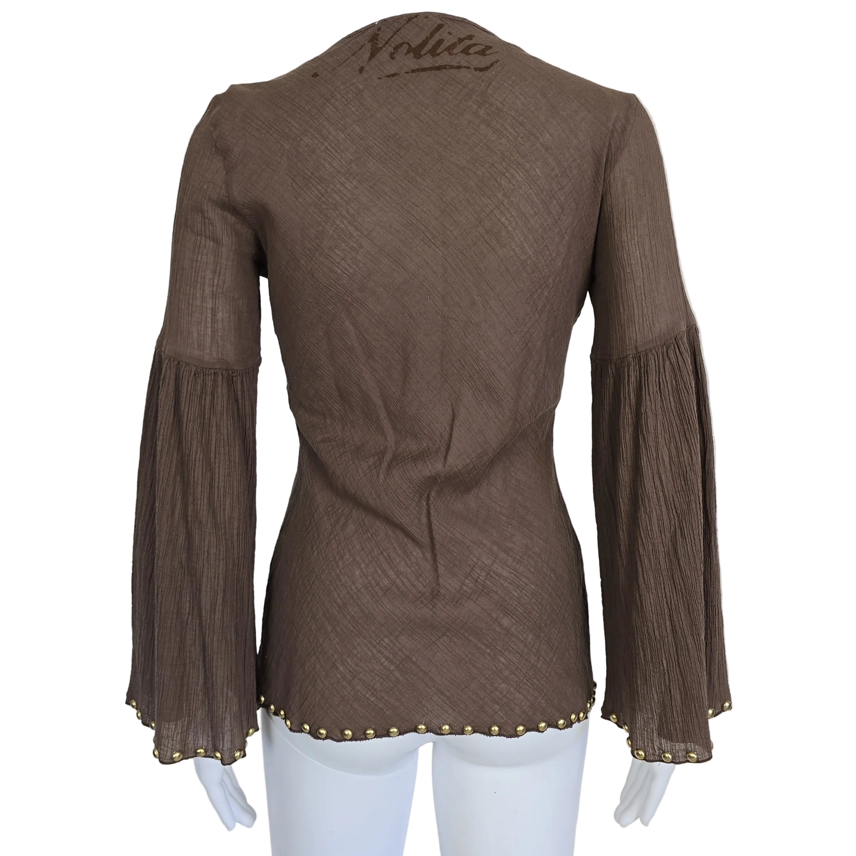 Brown garment with floral embroidery and gold studs on a light background