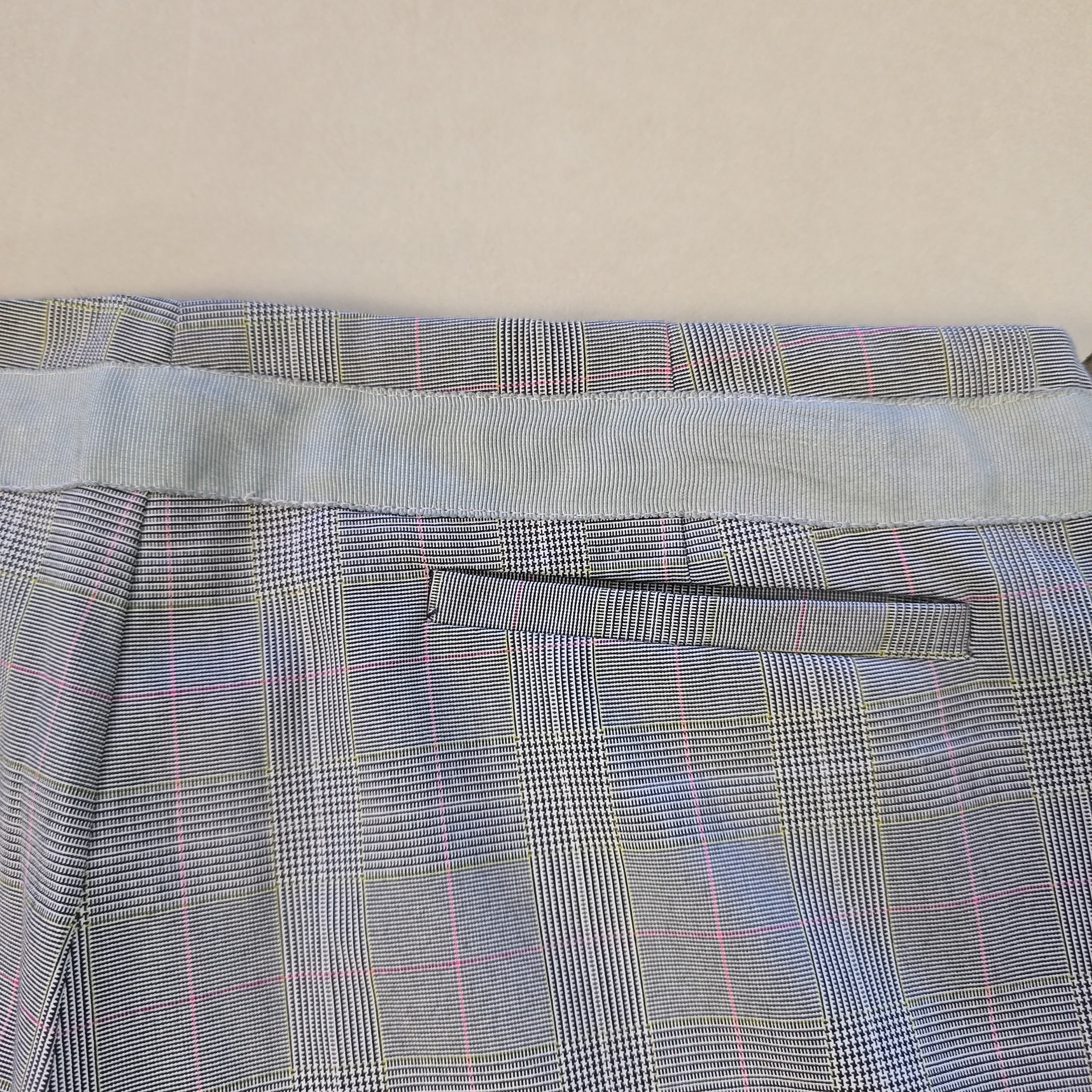 Plaid patterned fabric on a beige background