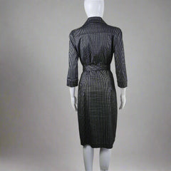 Mannequin wearing a dark gray dress on a neutral background