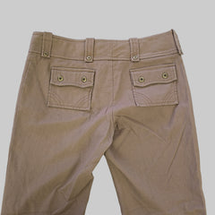 Brown pants with button details on a light gray background