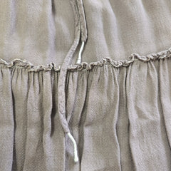 Close-up of a beige fabric with ruched detailing