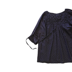 Brown long-sleeve top on a light background