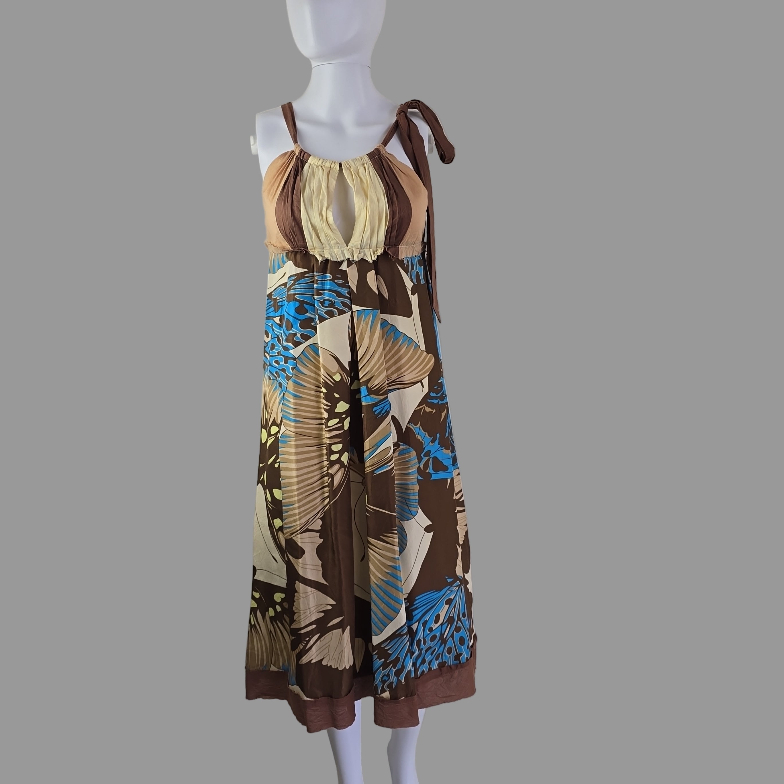 Mannequin wearing a patterned dress against a plain background