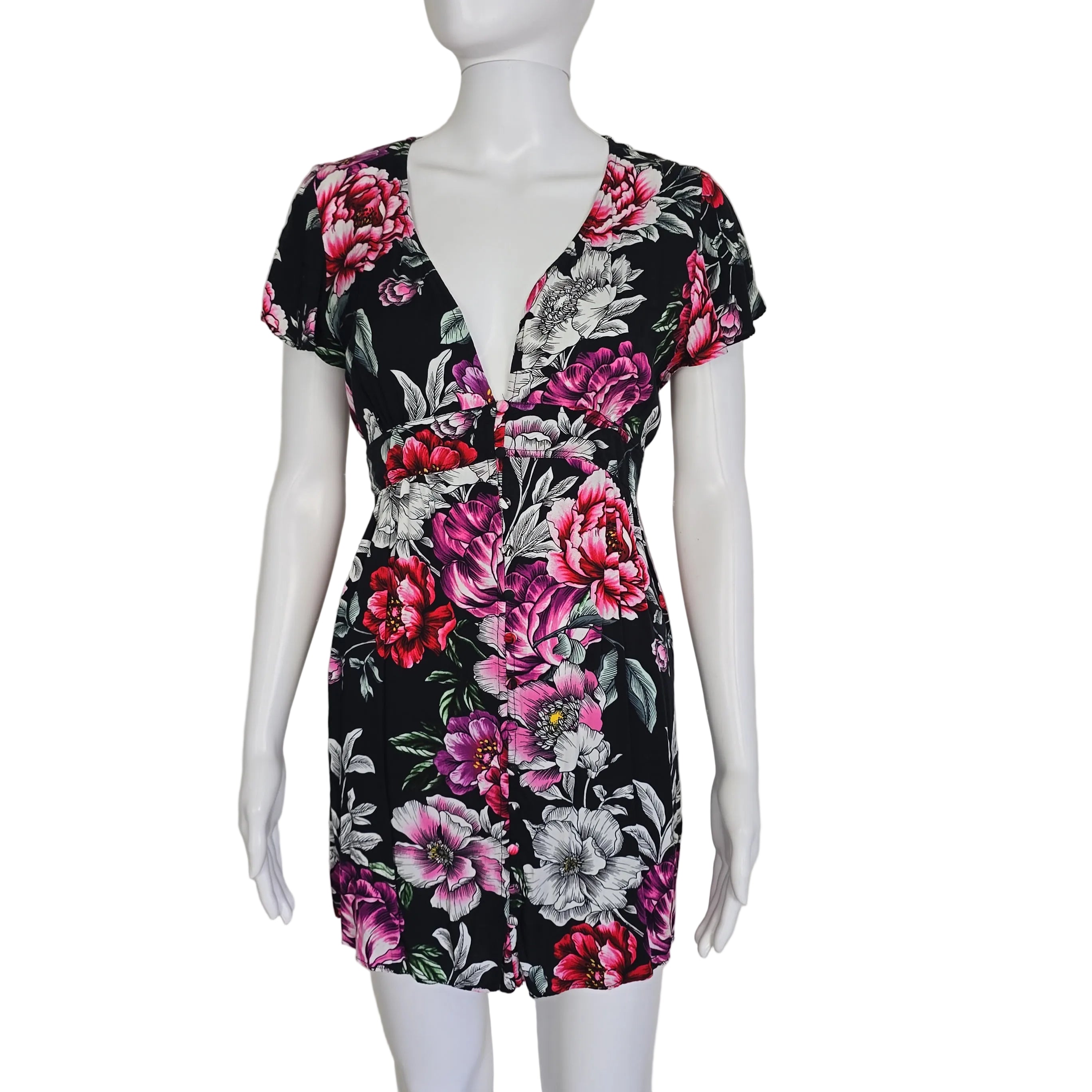 Floral dress on a mannequin against a plain background