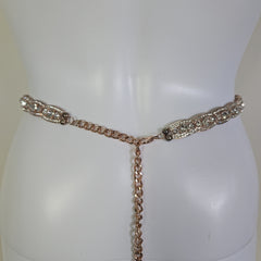 Rose gold chain belt on a mannequin with a plain background