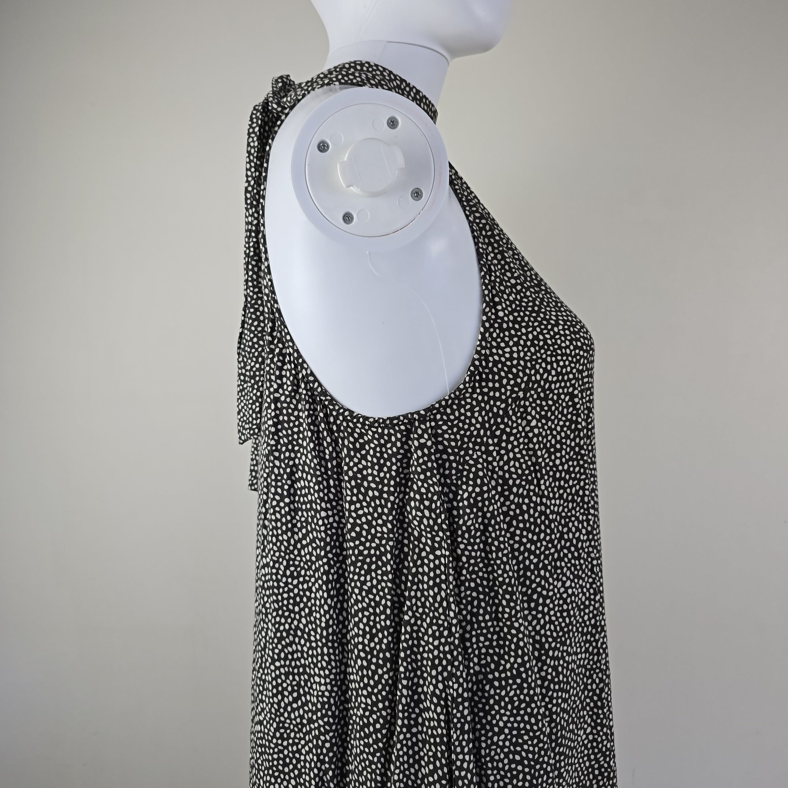 Grey and white spotted patterned dress on a light background