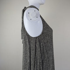 Grey and white spotted patterned dress on a light background