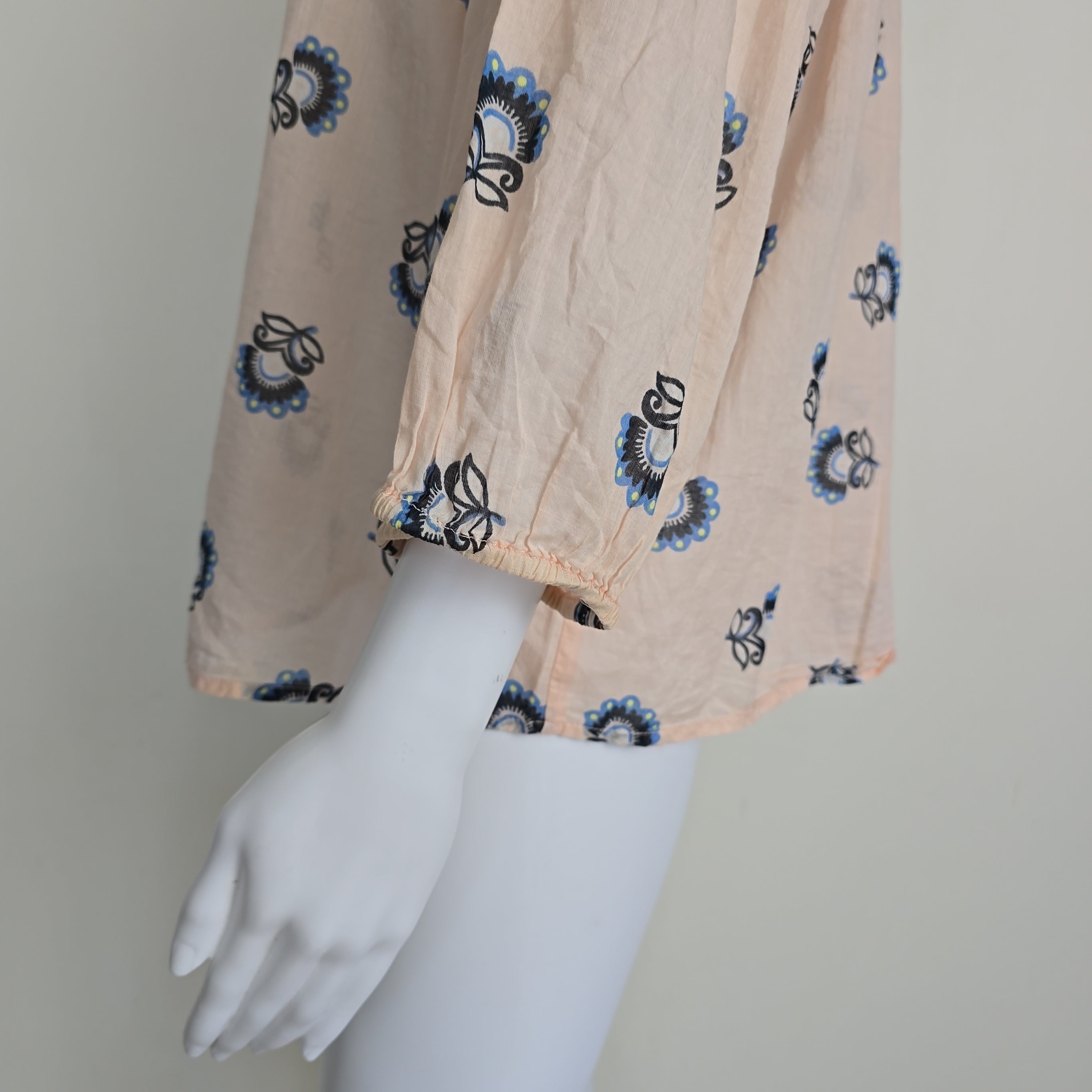 Floral-patterned flowy top on a light background