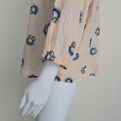 Floral-patterned flowy top on a light background