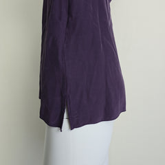 Purple fabric on a mannequin against a plain background