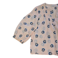 Floral-patterned flowy top on a light background