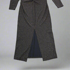 Black and gold textured dress against a light gray background