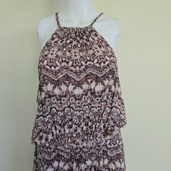 Patterned dress on a mannequin against a plain background