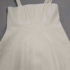 Close-up of a strapless white dress on a tiled floor