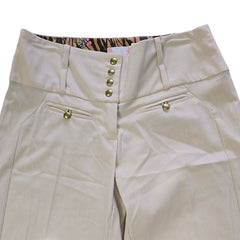 Beige pants with gold buttons on a light backgound