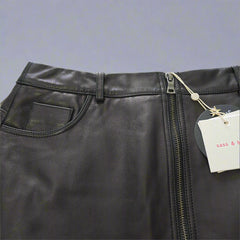 Black leather bag with a visible brand tag on a light background