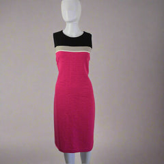 Mannequin arm with a bright pink dress on a light background