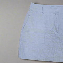 Light blue skirt on a beige tiled floor