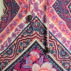 Close-up of a colorful fabric with floral and paisley patterns.