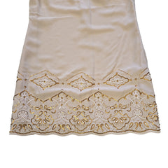 White fabric with gold lace trim on a light background
