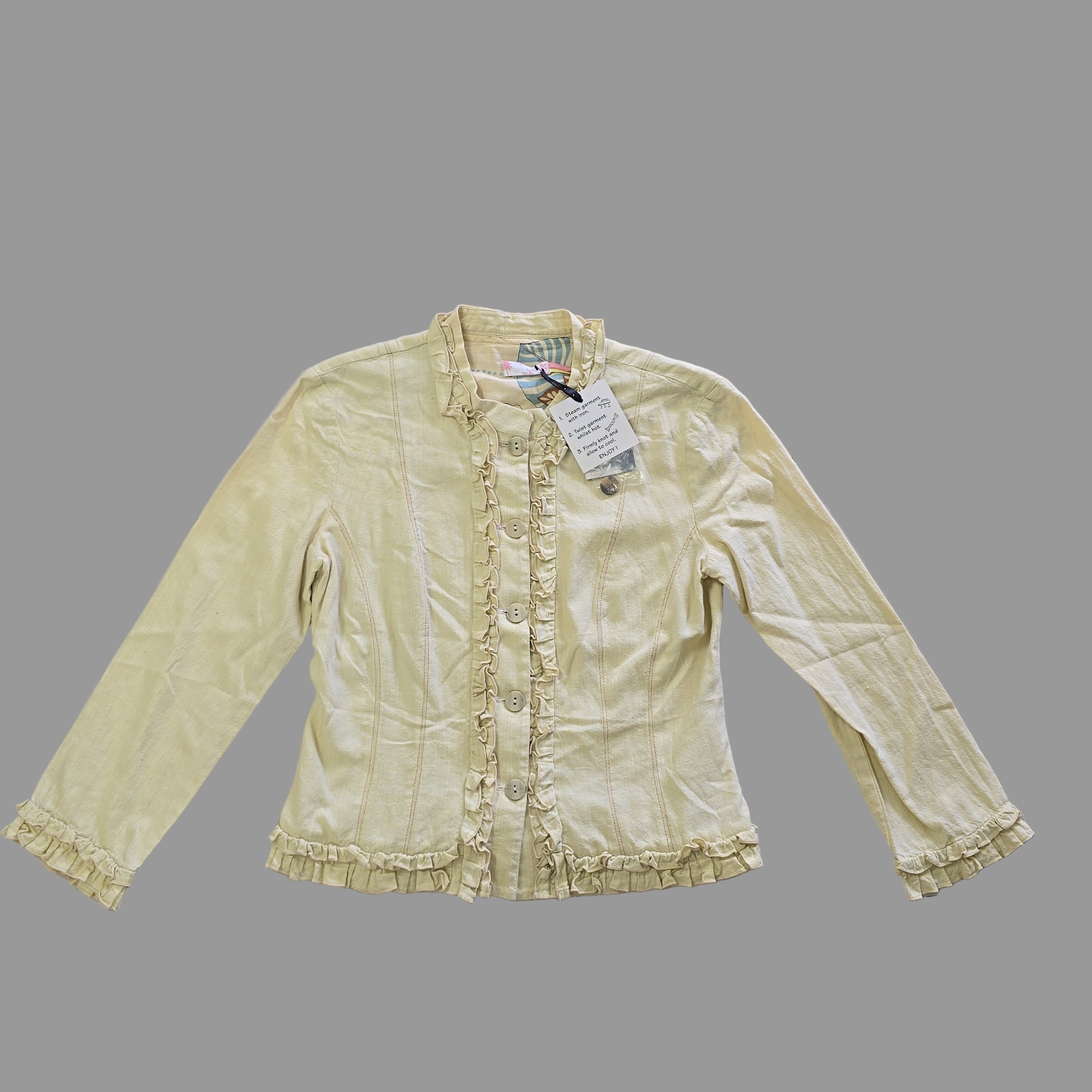 Light yellow jacket with frill details on a light background