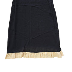 Black dress with beige lining on a light floor