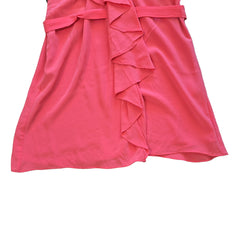 Pink dress with ruffled details on a light background