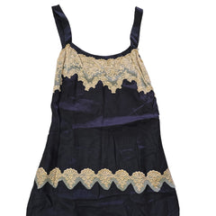 Black dress with beige lace details on a light background